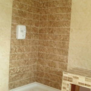 Tiled built in bath feature and shower room