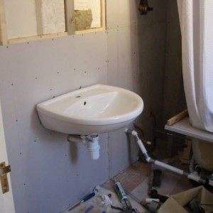 Sink fitted to check position. 
Note temporary bath arrangement!