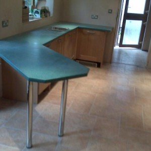 16k Oak Kitchen Installation with Silica(resin) worktops. Birds mouth cut for breakfast bar