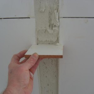 FILL GAP WITH ADHESIVE AND SCREED
WITH CUT TILE