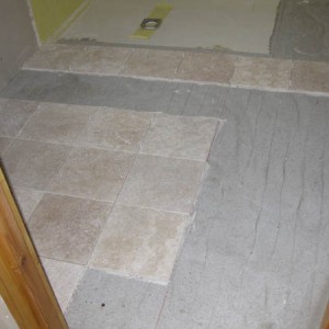 Oct 2008 First tiles go down. Substrate is: Chipboard, 12mm ply, durabase CI (thanks Wetdecs), ufc & 3mm of slc.