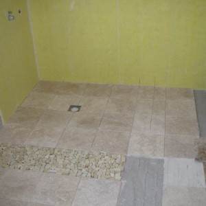 Nov 2008 First sandstone mosaic pebble added, shower area tanked with durabase WP. The rest is unfilled travertine.