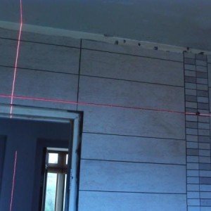 To the right of the door, that horizontal laser line runs perfectly matched from the left of the room to the right up till the shower mosaic then everything falls apart...