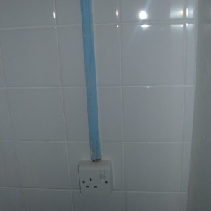 Socket cleaned and conduit tiled around.