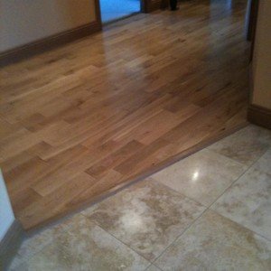 F&H Travertine entrance tile meeting solid oak flooring