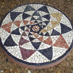 Circle of triangles, detail from a 3rd century AD Roman mosaic. The pattern originally appears in earlier Greek mosaics.
44cm doameter garden paving slab.