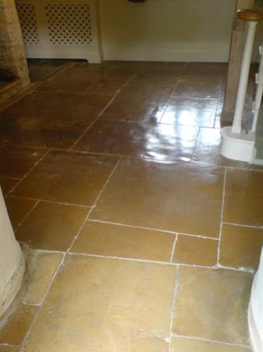 300 year old limestone.  Cleaned, regrouted and sealed with a linseed based impregnating sealant.  Then burnished with a high speed polisher.