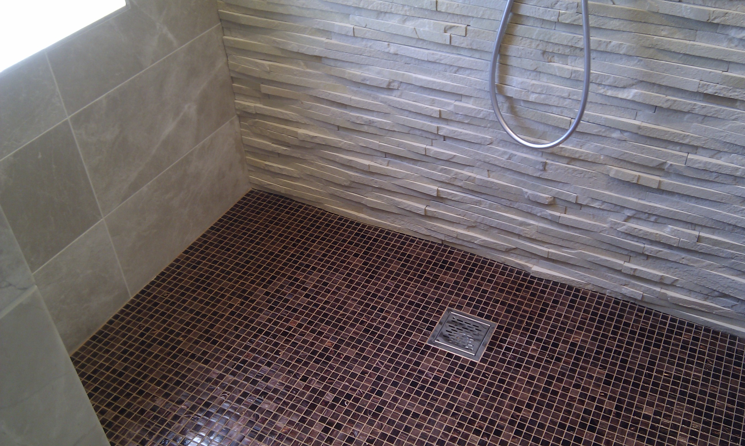 Bisazza and natural stone wetroom.