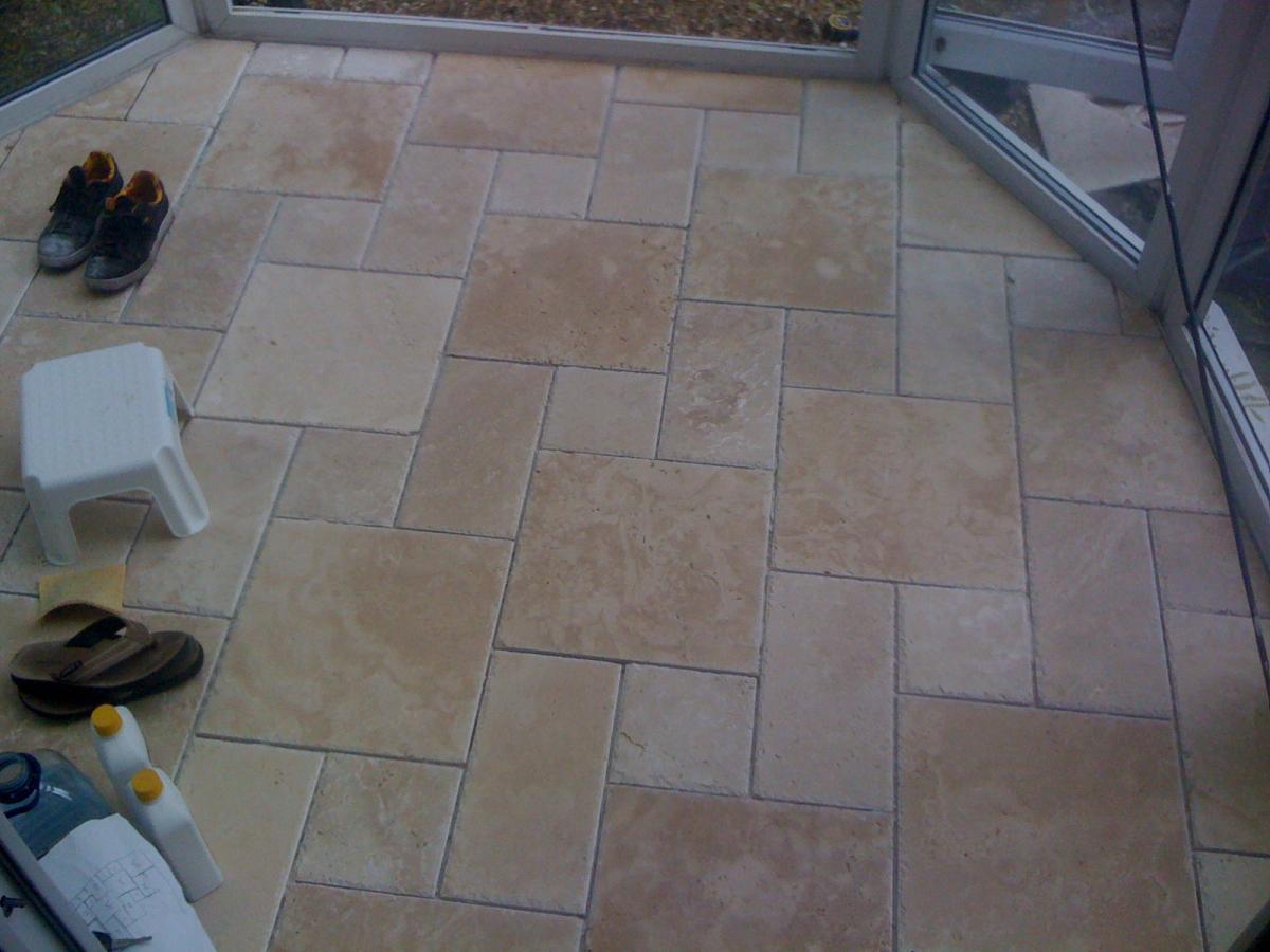 Chiselled edge travertine in the classic step pattern in this conservatory