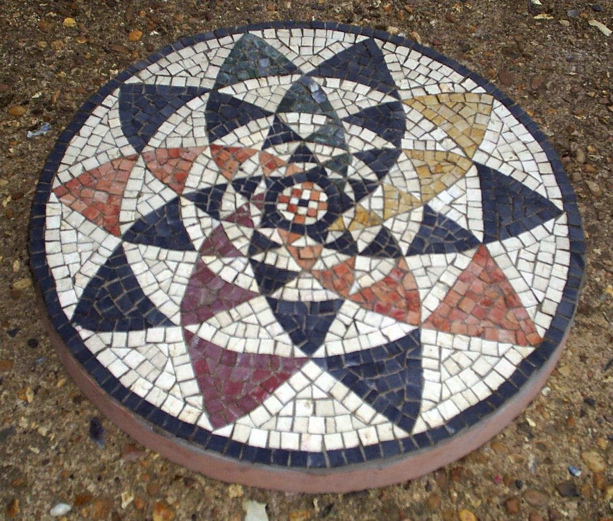 Circle of triangles, detail from a 3rd century AD Roman mosaic. The pattern originally appears in earlier Greek mosaics.
44cm doameter garden paving slab.