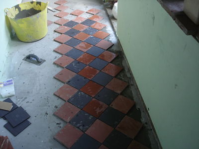 Cloister 8 - And off we go. Oh damn. the black tiles are smaller than the red ones so do away with the spacers......