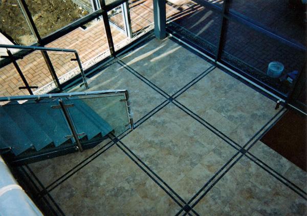 COMMERCIAL RECEPTION - 'STONE EFFECT' TILE WITH POLISHED PORCELAIN INLAYS.