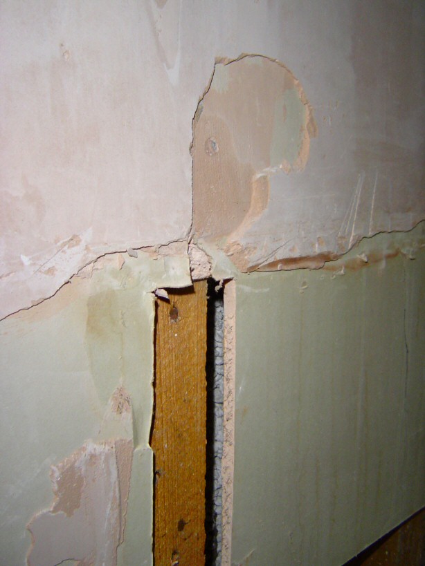 detail of east wall at  bath head showing  bare plasterboard and stud