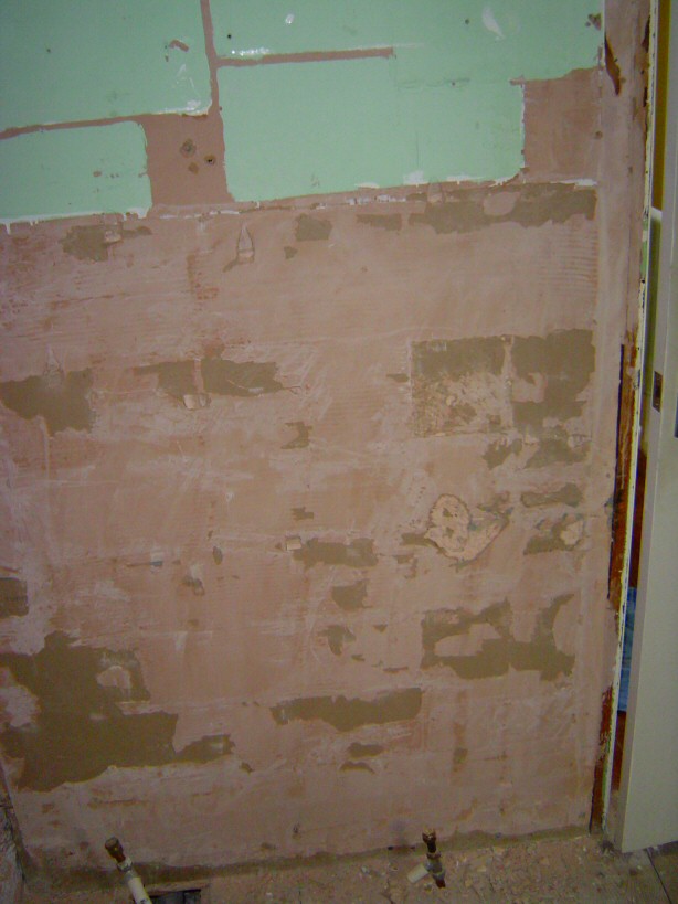 east wall ajacent north wall ,  mostly skimmed plasterboard, with plastered metal lath on stud wall from height of door top up to ceiling