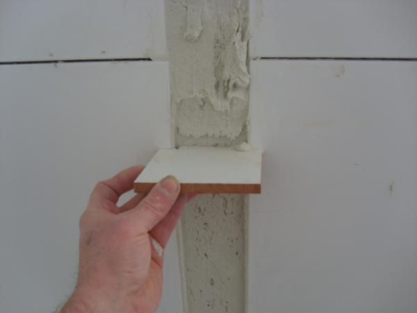 FILL GAP WITH ADHESIVE AND SCREED
WITH CUT TILE