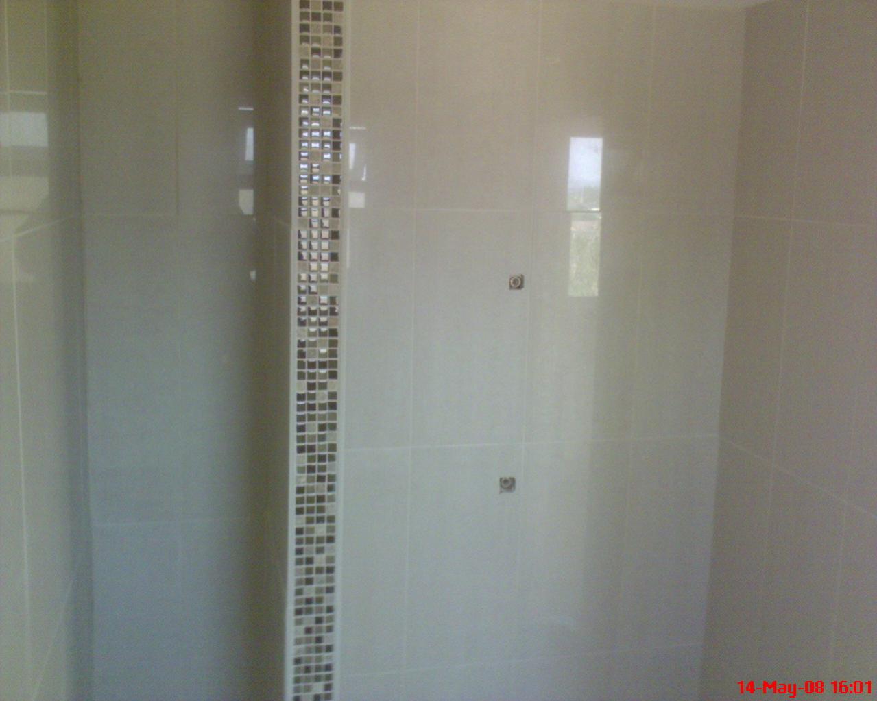 getting around an ugly end of wall in shower cubicle with vertical mosaic..