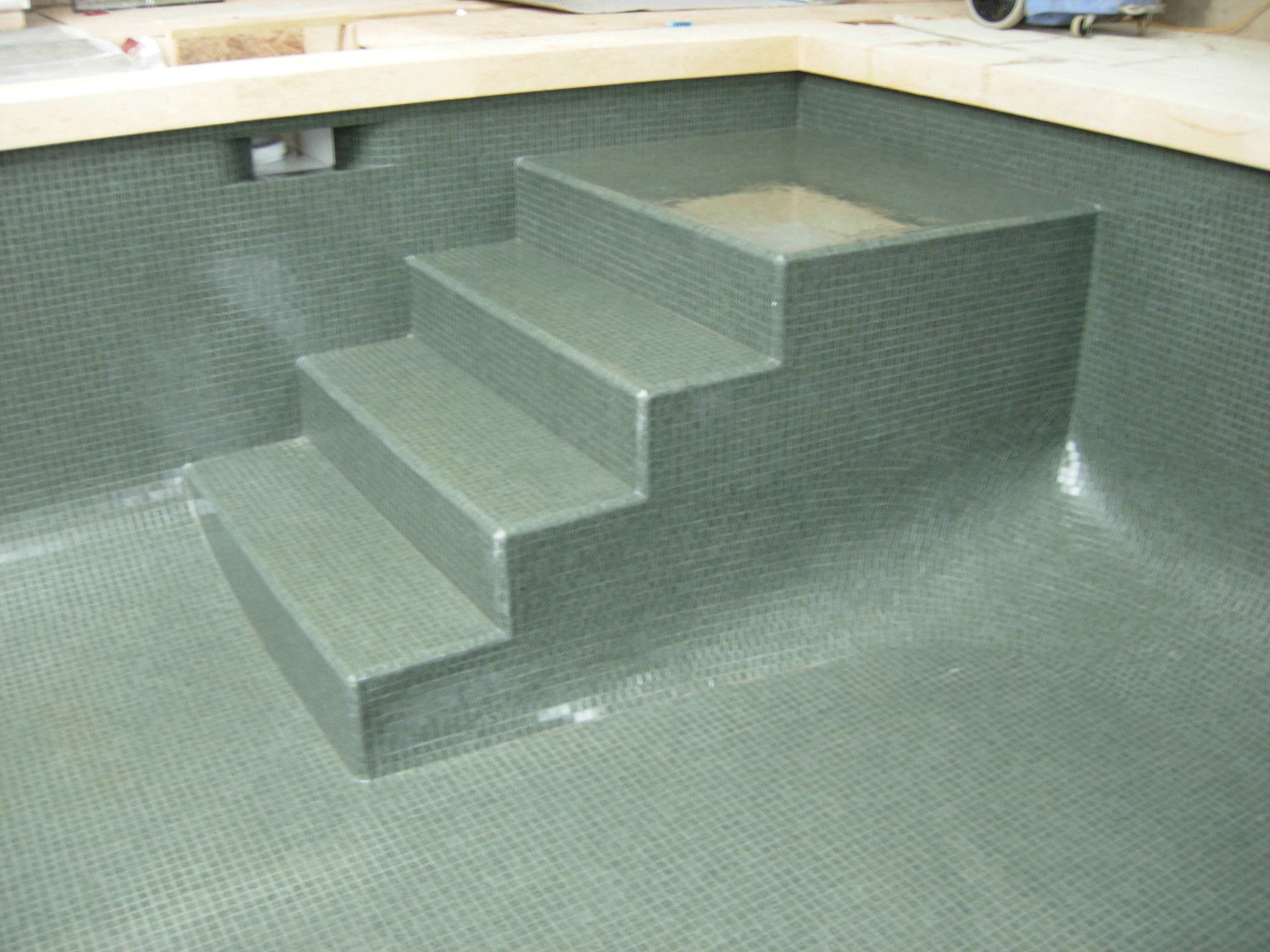 grey glass mosaic steps in pool