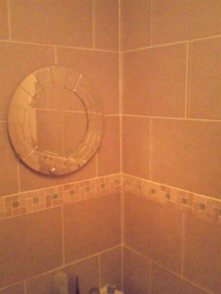 lines of symmetry in my tile work and a small mirror i fitted and the joint i siliconed up ..