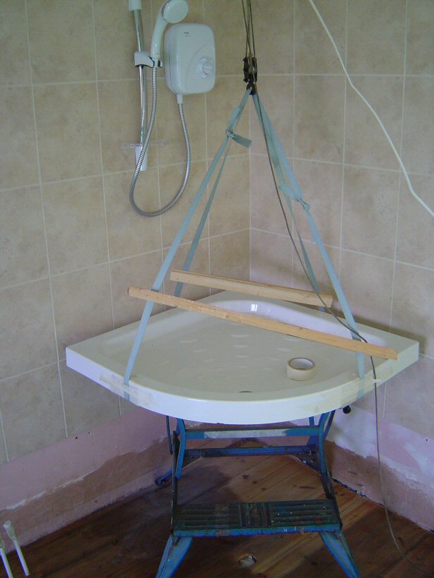 manoeuvring shower tray into corner onto mortar bed