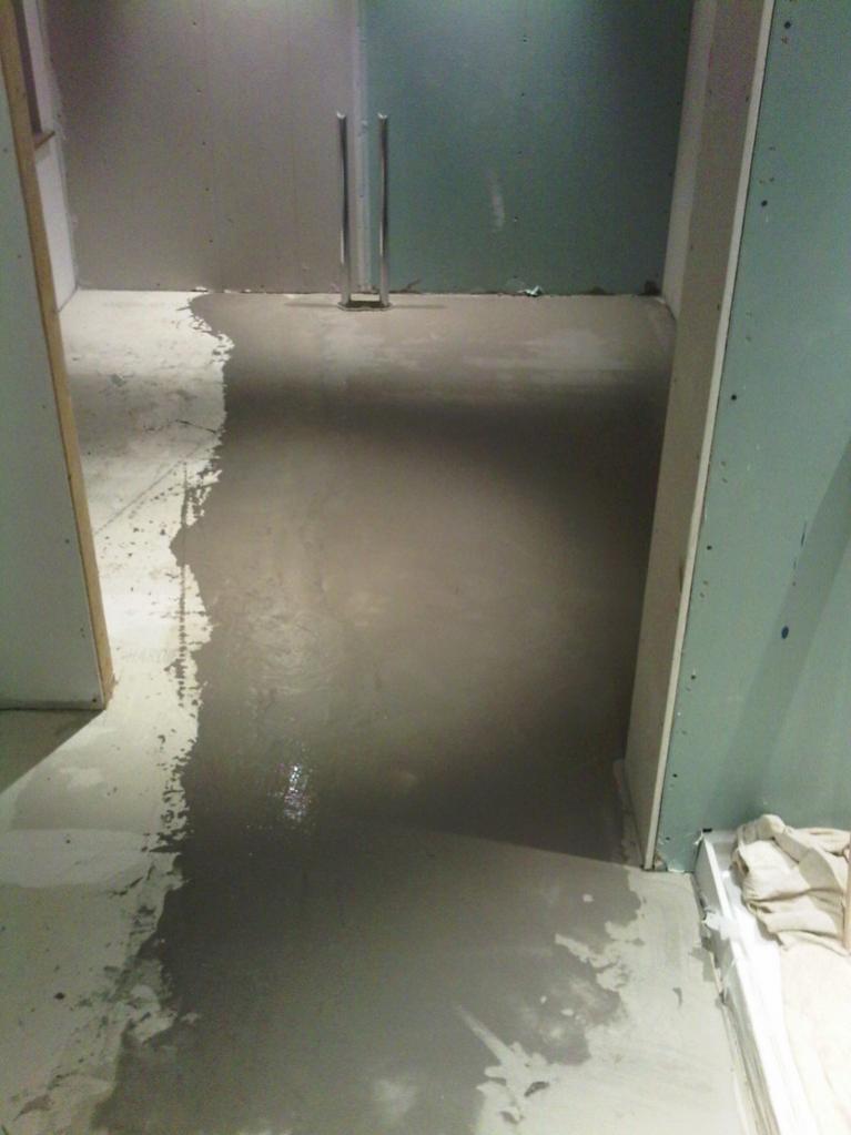 Master EnSuite - Flexible, reinforced self levelling compound screeded off the top of the strip of HBB using an 1800mm straight edge to provide a flat and level floor for tiling.