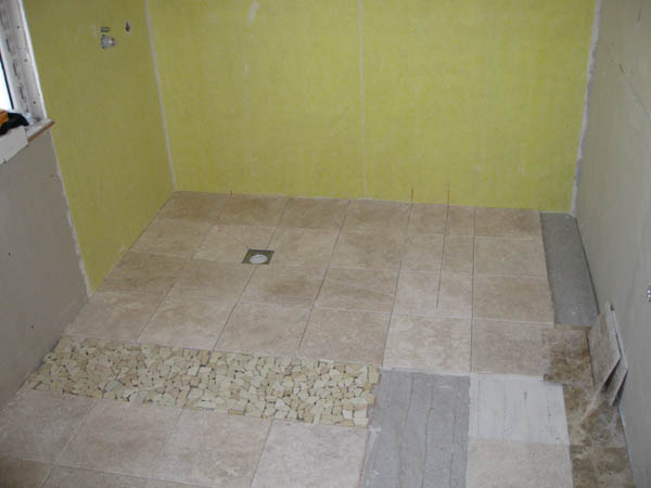 Nov 2008 First sandstone mosaic pebble added, shower area tanked with durabase WP. The rest is unfilled travertine.