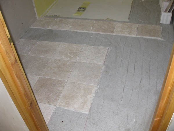 Oct 2008 First tiles go down. Substrate is: Chipboard, 12mm ply, durabase CI (thanks Wetdecs), ufc & 3mm of slc.