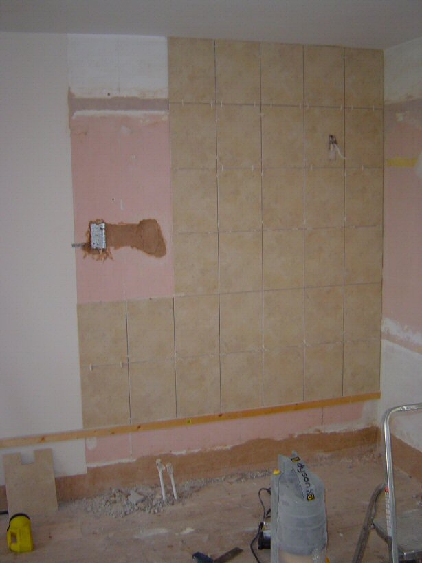 one wall nearly tiled, shower water and electrics in, shaver socket electrics in