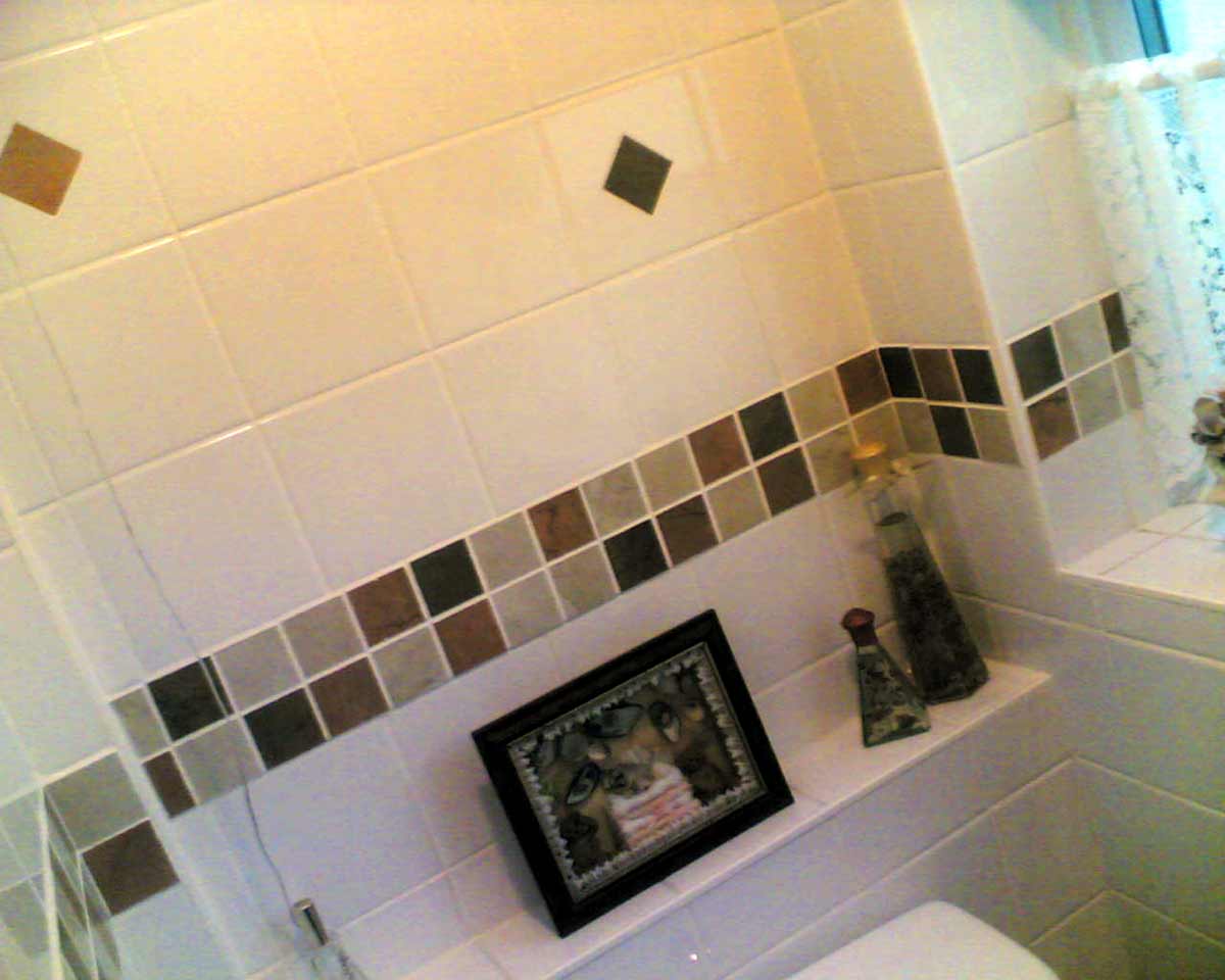 standard white tiles, cut to accept the mosaic inserts