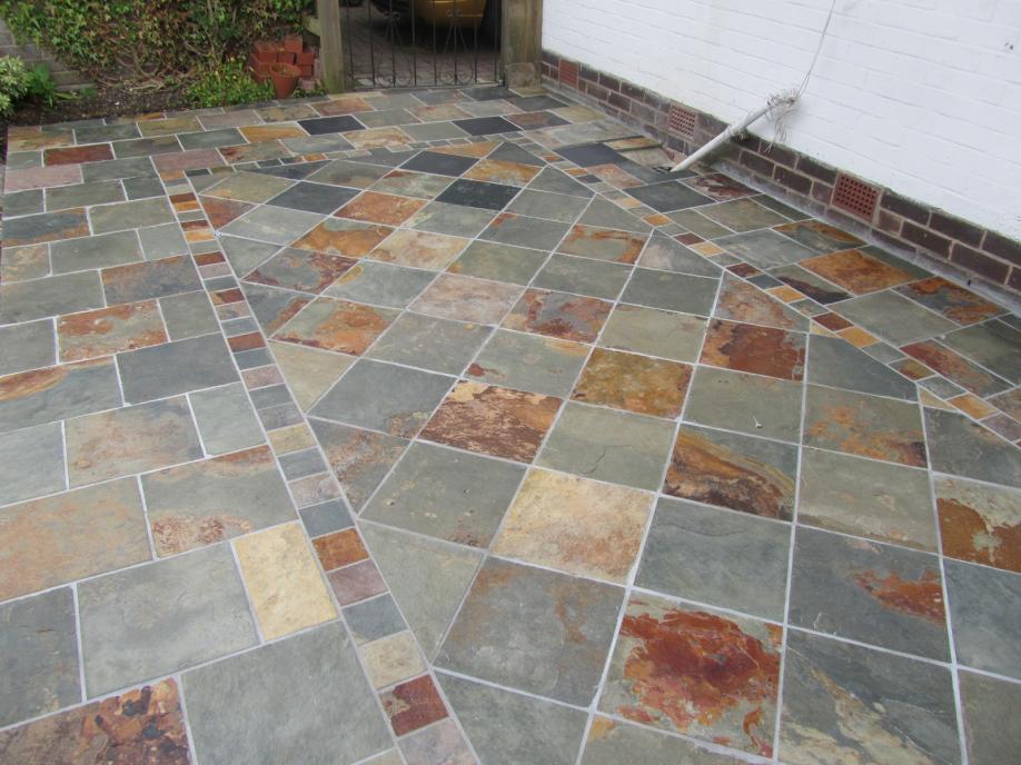 The Patio, my first attempt at natural stone, 18 Sq metre's using 300 x 300 natural riven slate from Wickes, cut to form central pattern. BAL adhesive & Groat. Total cost around £600, labour free....lol.....