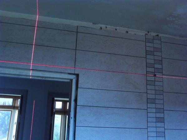 To the right of the door, that horizontal laser line runs perfectly matched from the left of the room to the right up till the shower mosaic then everything falls apart...