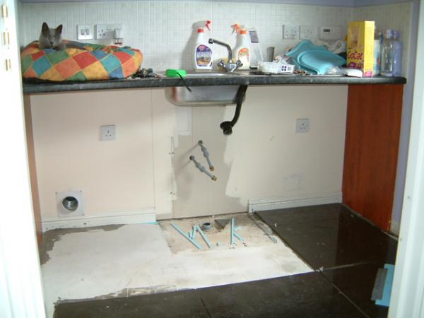 Utility Room. Cabinet removed to allow tiles to extend underneath. Cabinet sides cut to fit.