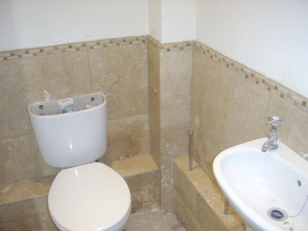 WC USING TRAVERTINE TILES AND BORDER