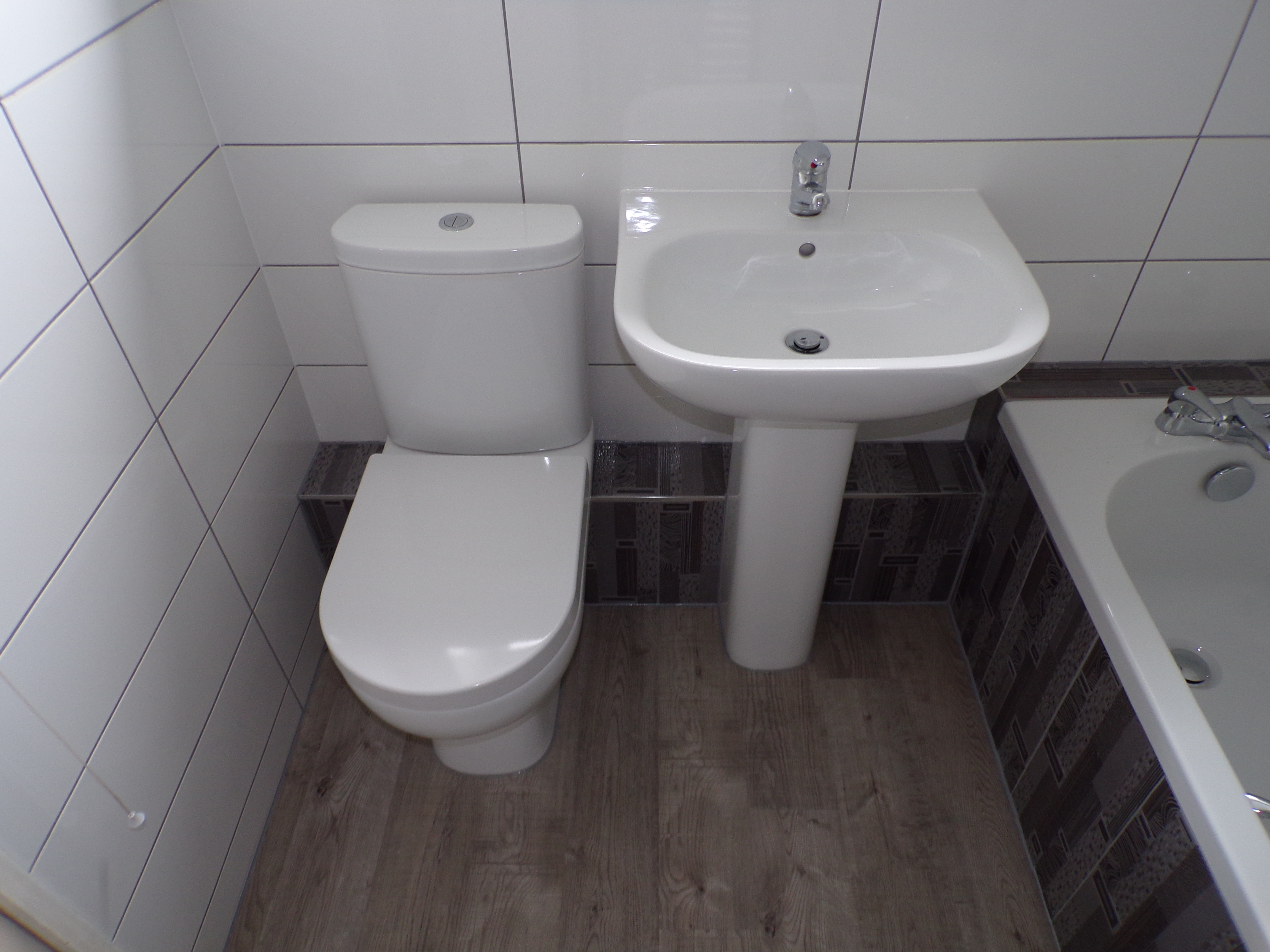 White tiles with feature decors and grey grout